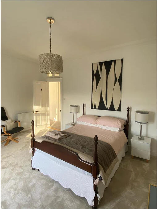 Bedroom 1, a double room with blush bedding and monochrome art