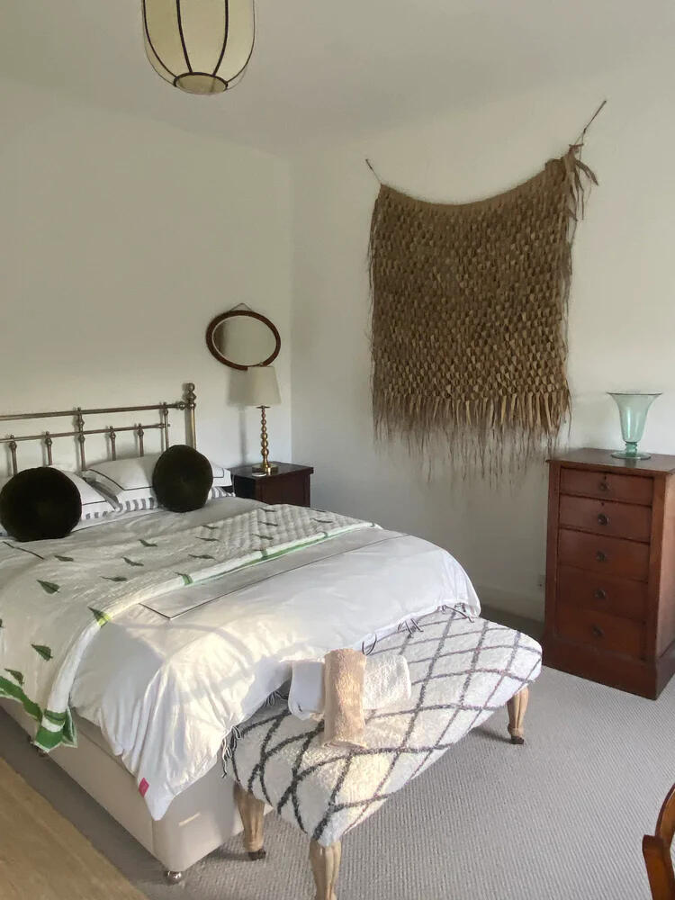 Bedroom 2, with a king size bed and a palm leaf wall hanging