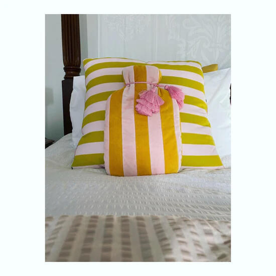 A striped cushion on a bed