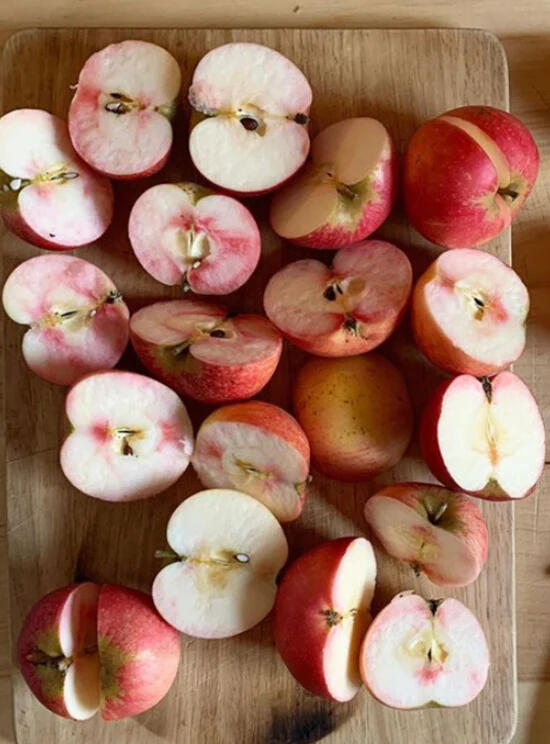 Freshly cut apples from the orchard on a wooden board